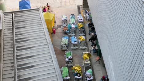 Rows-of-patients-with-Covid-19-symptoms-lying-in-the-bed-in-the-street-outside-an-overcrowded-hospital-while-the-medical-system-collapses-with-hospitalizations