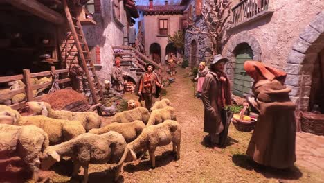 Christmas-modern-representation-of-village-life-scene-with-nativity-shepherd-and-sheep-painted-statues
