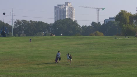 Families-with-children-walk-on-a-huge-grass-field-in-Tel-Aviv's-Yarkon-Park-#012
