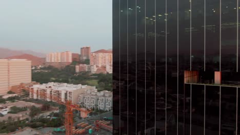 Revealing-aerial-shot-of-Surco-District-corporate-buildings-at-sunset