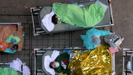 Chinese-patients-with-Covid-19-symptoms-lie-in-beds-as-they-are-being-treated-outside-an-overcrowded-hospital-while-the-medical-system-collapses-with-hospitalizations