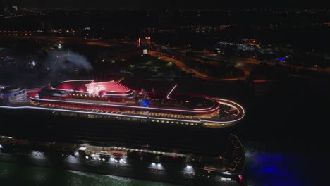 Aerial-shot-of-cruise-liner-passing-by-at-night