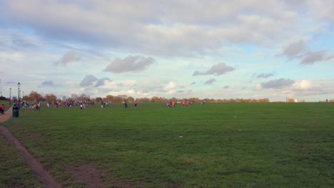 Shot-of-locals-in-Blackheath-public-park-in-south-east-London,-UK-on-a-cloudy-evening