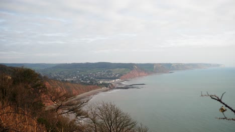 Wide-shot-of-the-Jurassic-coast-looing-east-over-the-cliffs-surrounding-the-historic-town-of-Sidmouth,-Devon,-UK