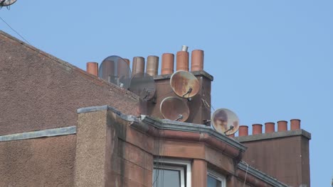 Ultra-close-up-shot-of-a-group-of-tv-aerials-on-a-tenement-roof