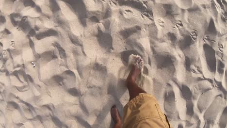 Black-feet-walking-across-sandy-beach,-Looking-Down-Point-of-View