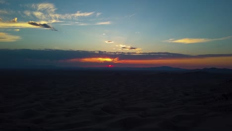 Beautiful-vivid-aerial-view-from-a-drone-of-a-sunset-looking-out-at-many-sand-dunes-in-the-Little-Sahara-desert-in-Joab-Utah