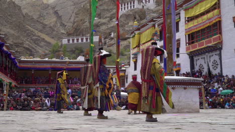 Monks-wearing-colorful-masks-and-dresses-performing-dances-infront-of-tourists-at-Hemis-festival-in-monastery