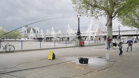 Street-Performer-Creating-Bubbles-At-Southbank-With-Children-Chasing-Them-In-London