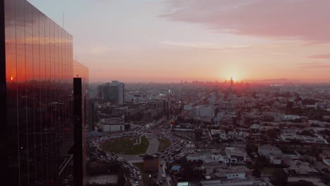 Drone-footage-of-Lima-City-passing-by-the-side-of-a-corporate-building-on-Surco-District