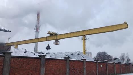 Gantry-crane-used-to-transport-coal-in-sugar-factory-in-Malbork,-Poland-on-snowy-winter-day