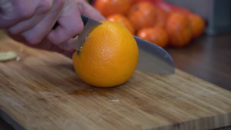 Chopping-juicy-orange-on-cutting-board-organically
