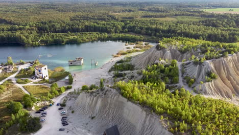 Aerial-landscape-Sand-Hills-of-Quarry-With-a-Pond-and-Abandoned-Prison-in-Rummu-Estonia-Europe