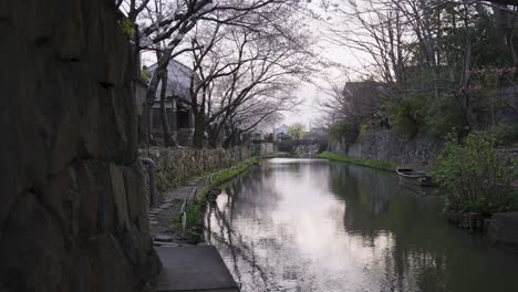 Omihachiman-Moat-in-Spring,-Sakura-Blooming-over-Peaceful-Ancient-Waterway