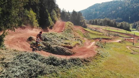 Motocross-riders-riding-on-the-left-turn-on-a-dirt-track