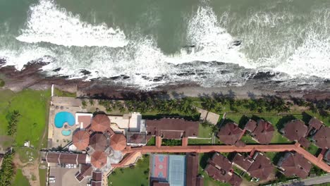 sea-waves-by-house-aerial-view-tracking