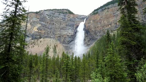 Stunning-static-wide-view-of-huge-waterfalls-falling-down-rocky-mountain-range