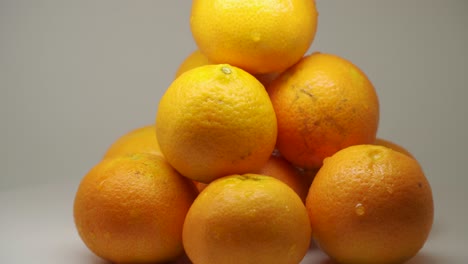Ten-Juicy-Oranges-Turning-Clockwise-On-A-Turntable---Close-Up-Shot