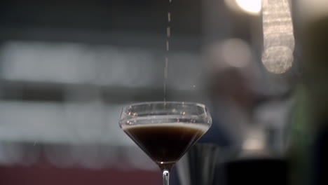 closeup-of-a-bartender-dripping-a-cocktail-in-a-glass