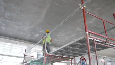 Construction-site-workers-are-doing-ceiling-soffit-skim-coat-work-at-the-construction-site