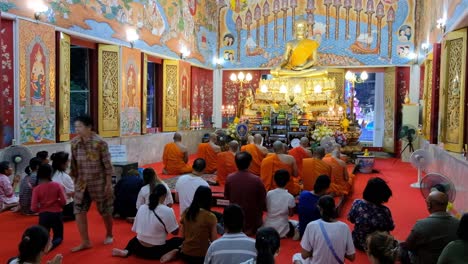 Los-Devotos-Budistas-Y-Los-Monjes-Rezan-Dentro-De-Un-Templo,-Día-De-Makha-Bucha