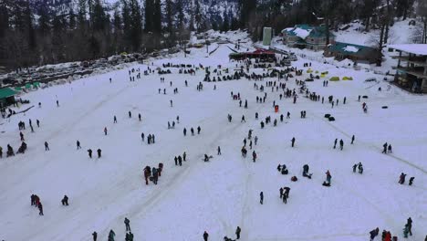 Aerial-moving-shot-of-a-crowded-snow-valley-revealing-solang-valley-,-himachal-pradesh