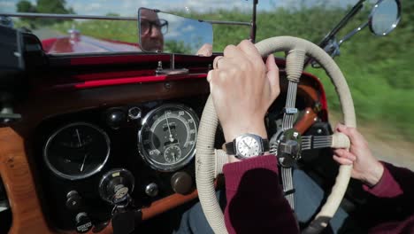 Red-1939-Morgan-4-4-'Le-Mans'---dash-view---SLOMO---open-top-sports-car-in-English-countryside-on-a-picture-perfect-day
