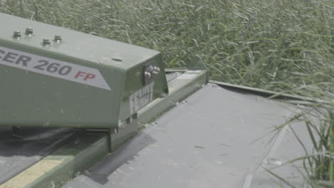 Tractor-front-mounted-mower,-slicer-cutting-grass-close-up