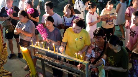 Buddhist-Worshipers-Light-Candles-At-Makha-Bucha-Day,-Thailand