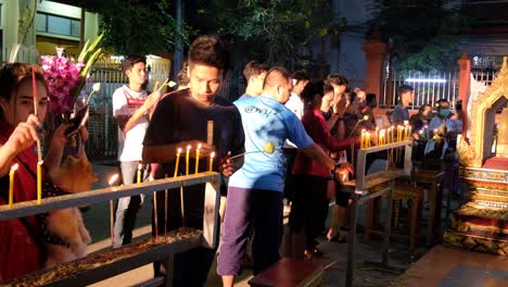 Worshipers-Light-Candles-For-Makha-Bucha-Day,-Thailand-At-Night
