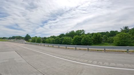 POV-while-driving-on-Interstate-74-highway-that-runs-parallel-to-a-frontage-road-in-the-Quad-Cities-in-Illinois