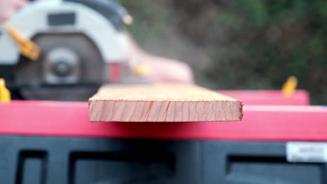 Power-Tool-in-Action,-Close-Up-Slow-Motion-Shot-of-Electric-Round-Saw-Cutting-Through-Wooden-Plank