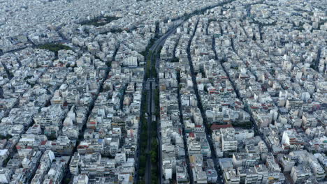 Drone-aerial-shot-over-Athens,-following-road-through-the-city,-Greece