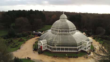Sefton-Park-Palm-house-Liverpool-Victorian-exotic-conservatory-greenhouse-aerial-botanical-landmark-dome-building-rising-pull-back