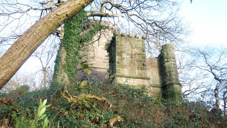 Abandoned-Autumn-woodland-watchtower-stone-castle-keep-building-in-rural-English-countryside-slow-right-dolly