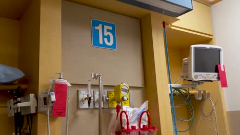 Slow-pan-down-of-medical-equipment-on-the-back-wall-of-an-emergency-room