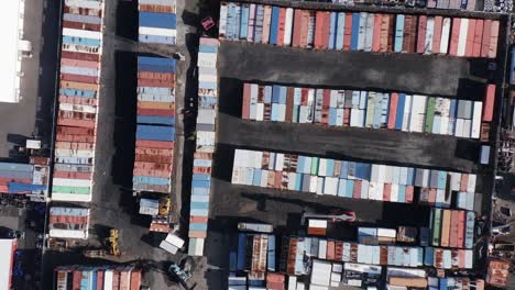 Colorful-containers-waiting-for-shipment-seen-from-above-at-storage-yard,-aerial