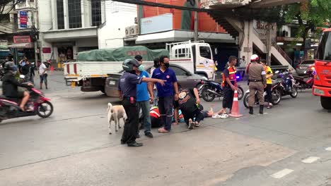 Motor-Bike-Rider-Victim-Lying-Down-The-Road-Intersection-Rescued-By-Traffic-Enforcers,-Tuesday-Morning-Of-June-23,-2020-In-Bangsue,-Bangkok,-Thailand---Slow-Motion