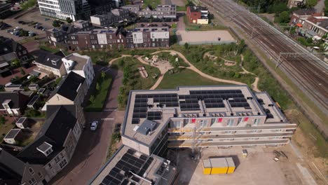Aerial-approach-and-reveal-of-construction-site-Ubuntuplein-in-urban-development-real-estate-investment-project-in-new-Noorderhaven-neighbourhood
