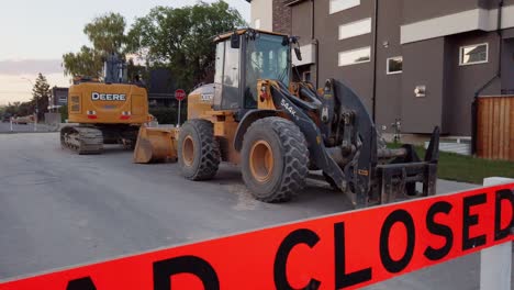 Bulldozer-road-closed-barricade-sign-in-street-residential-approached