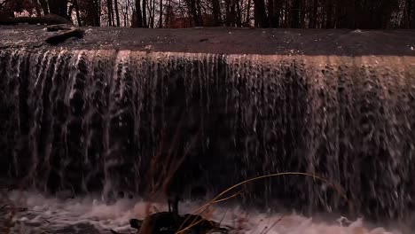 a-drone-flies-along-the-waterfall-at-sunset-beautiful-view