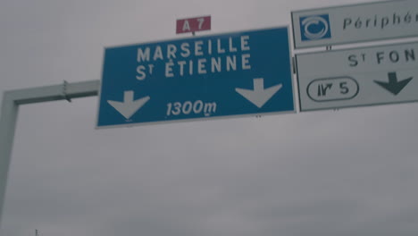 View-from-car-window-on-overhead-direction-sign-on-highway,-Marseille,-France