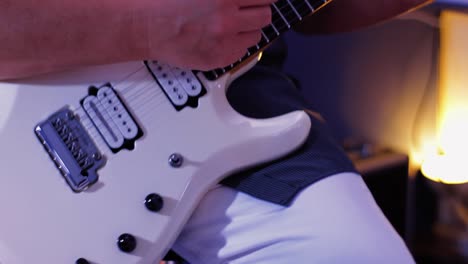 a-musician-playing-guitar-in-the-studio