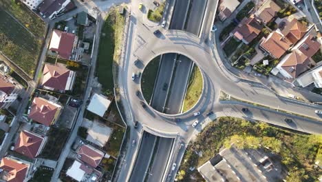 Aerial-drone-view-of-highway-multi-level-junction-road-with-moving-cars-at-sunset