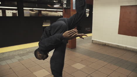 Janitor-dancer-flips-on-subway-platform-as-steadicam-wraps-around-as-train-pulls-away