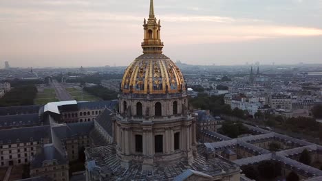 Aerial-Orbit-of-Les-Invalides-Golden-Dome-at-sunrise,-Revealing-Eiffel-Tower-in-the-Paris-city-in-background