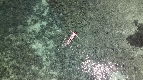 Aerial-View-Of-Single-Female-Snorkelling-In-Waters-At-Koh-Lipe