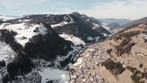 Dolly-forward-drone-shot-over-st-cristina-mountain-village-towards-Ortisei-Dolomites