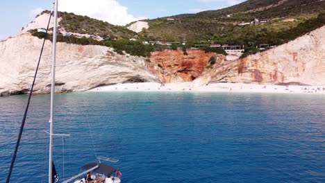 People-Relax-at-Luxury-Yacht-at-Porto-Katsiki-Beach,-Lefkada,-Greece---Aerial
