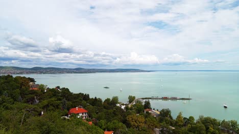 Gorgeous-long-exposure-timelapse-video-from-Hungary,-Tihany-peninsula,-looking-towards-the-northern-part-of-Lake-Balaton-including-the-ferry-port-and-sailing-boats-with-the-hills-in-the-background